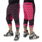First Earth Asanoha Pink three-quarter velvet harem shorts on model, showing front and back views with pink geometric pattern