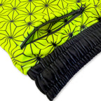 Close up of First Earth Asanoha Yellow velvet jogger shorts hip zipper pocket and soft fabric