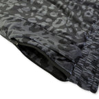 First Earth Midnight Cheetah jogger shorts close up showing side zipper pocket and dark velvet fabric