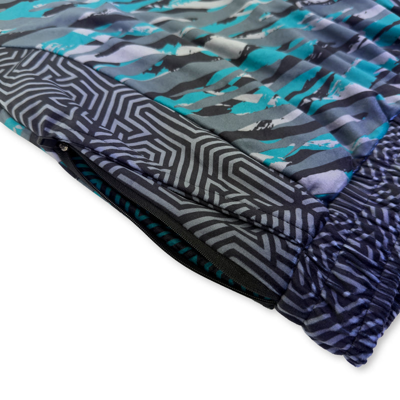 First Earth Shadow jogger shorts close up showing side zipper pocket and teal gray velvet artwork