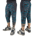 First Earth Shadow 3/4 velvet harem shorts on model showing front and back views with teal and grey abstract stripe pattern