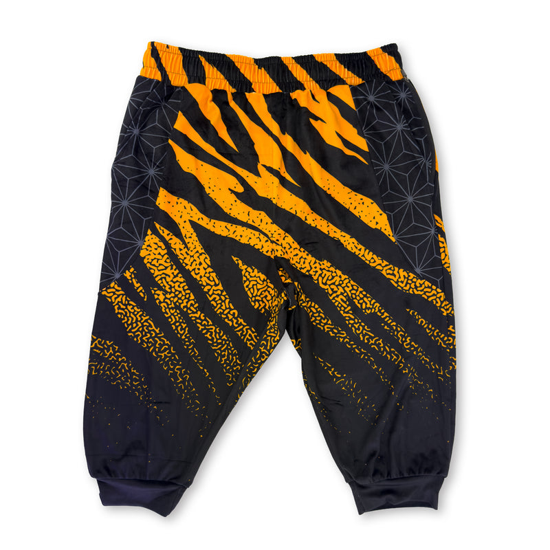 First Earth Sacred Stripes UV velvet 3/4 jogger shorts front with orange and black stripe print and geometric side panels