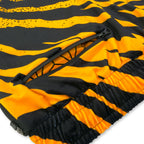 First Earth Sacred Stripes jogger shorts close up showing back zipper pocket and orange black velvet fabric