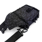 First Earth Midnight Cheetah sling bag front view with flap open and zipper pocket