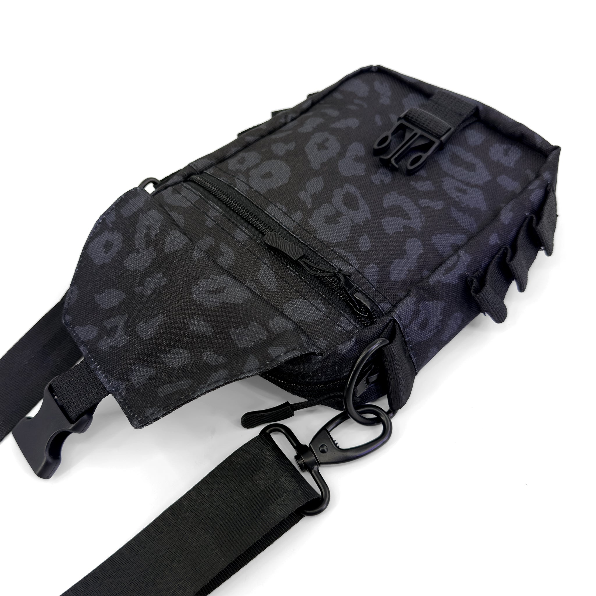 First Earth Midnight Cheetah sling bag front view with flap open and zipper pocket