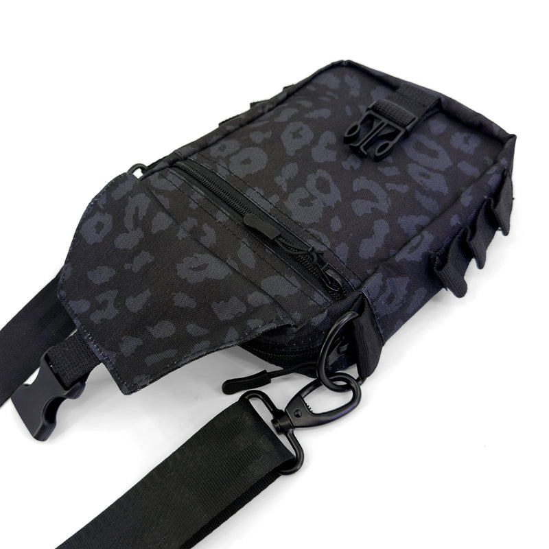 First Earth Midnight Cheetah sling bag front view with flap open and zipper pocket