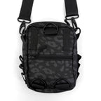 First Earth Midnight Cheetah sling bag back view with black straps and zipper pocket