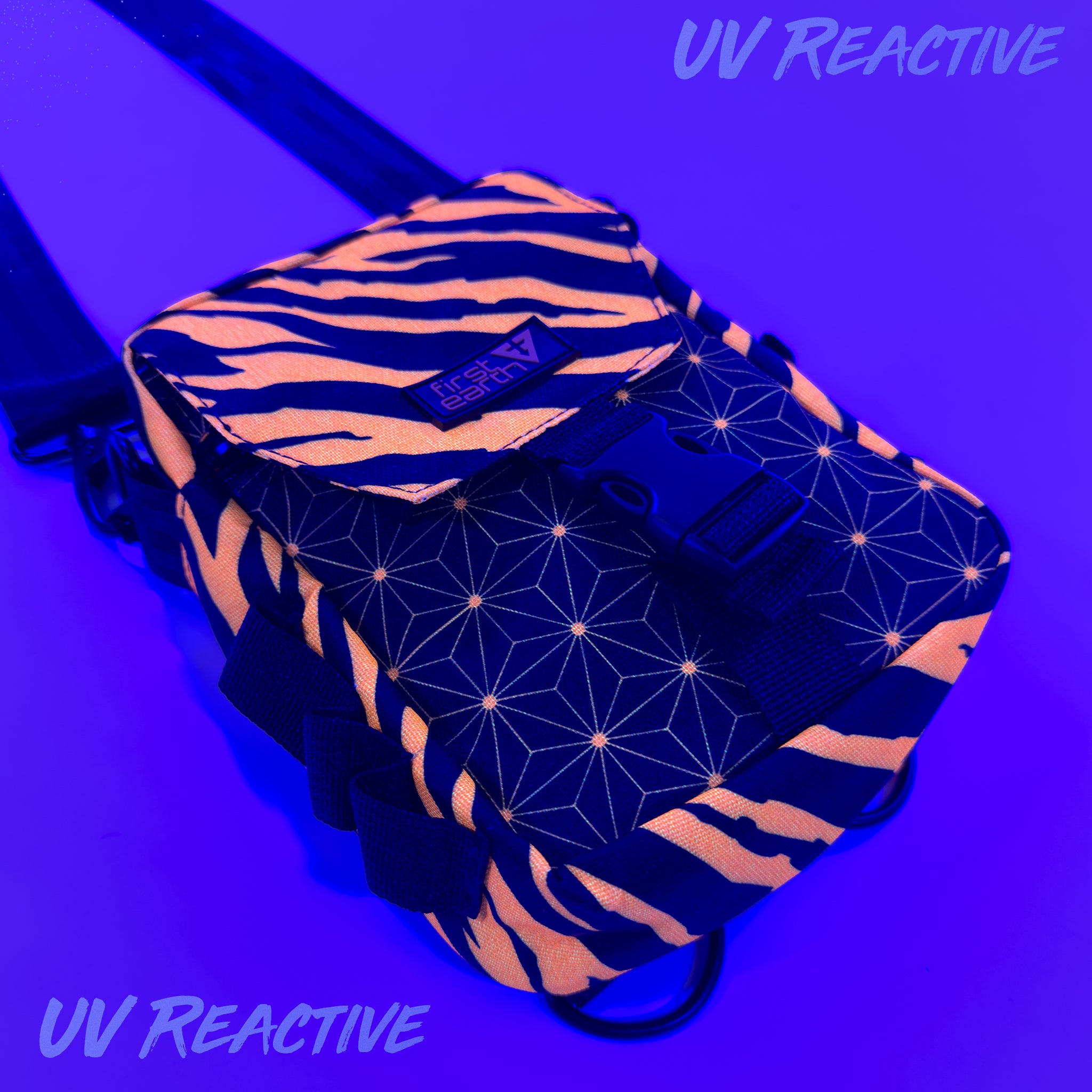 First Earth Sacred Stripes UV-reactive sling bag glowing orange under blacklight for rave and festival gear