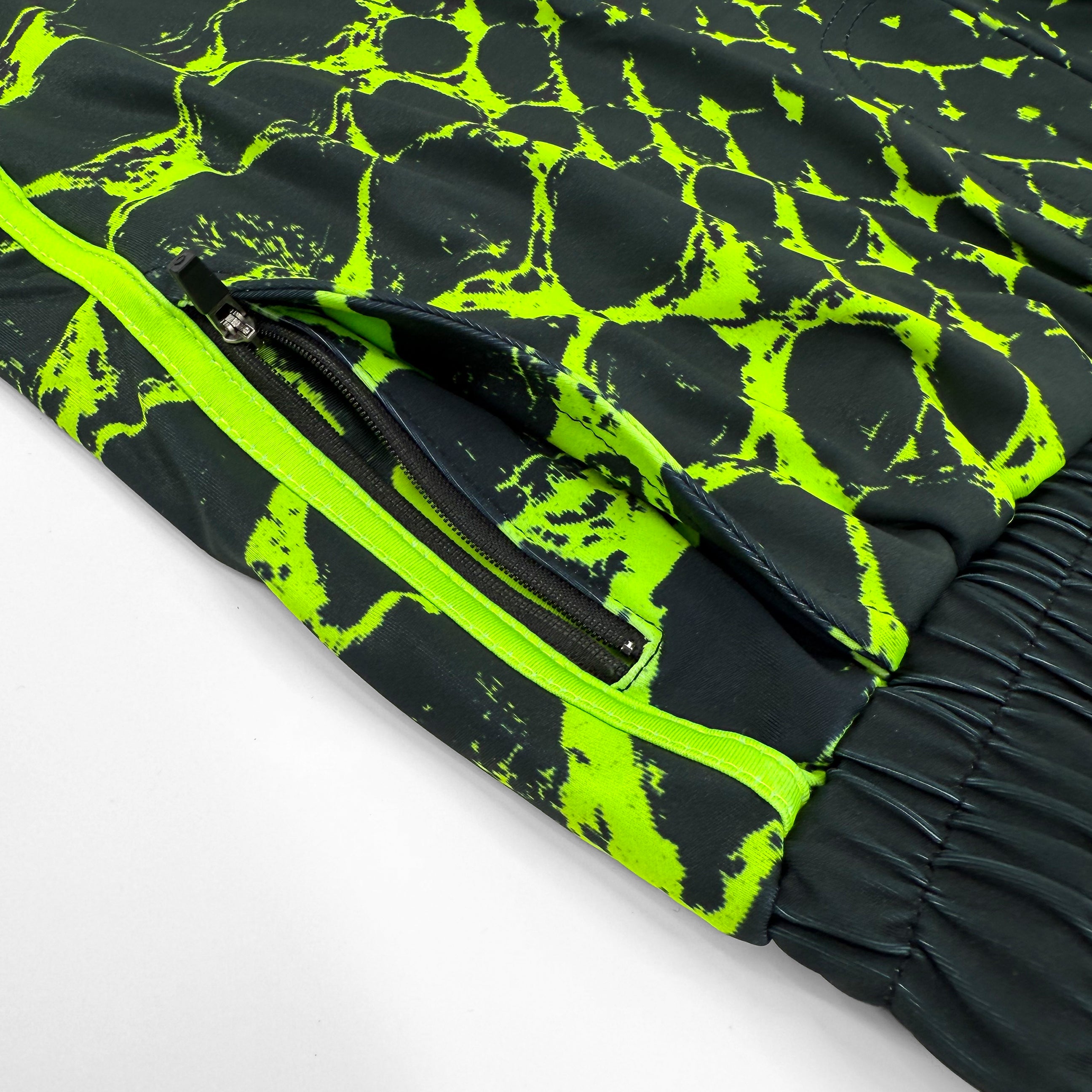 Neon Serpent UV shorts by First Earth – rave-ready shorts with glowing serpent design that shines under blacklight, lightweight breathable mesh, zip and velcro pockets for festival flow