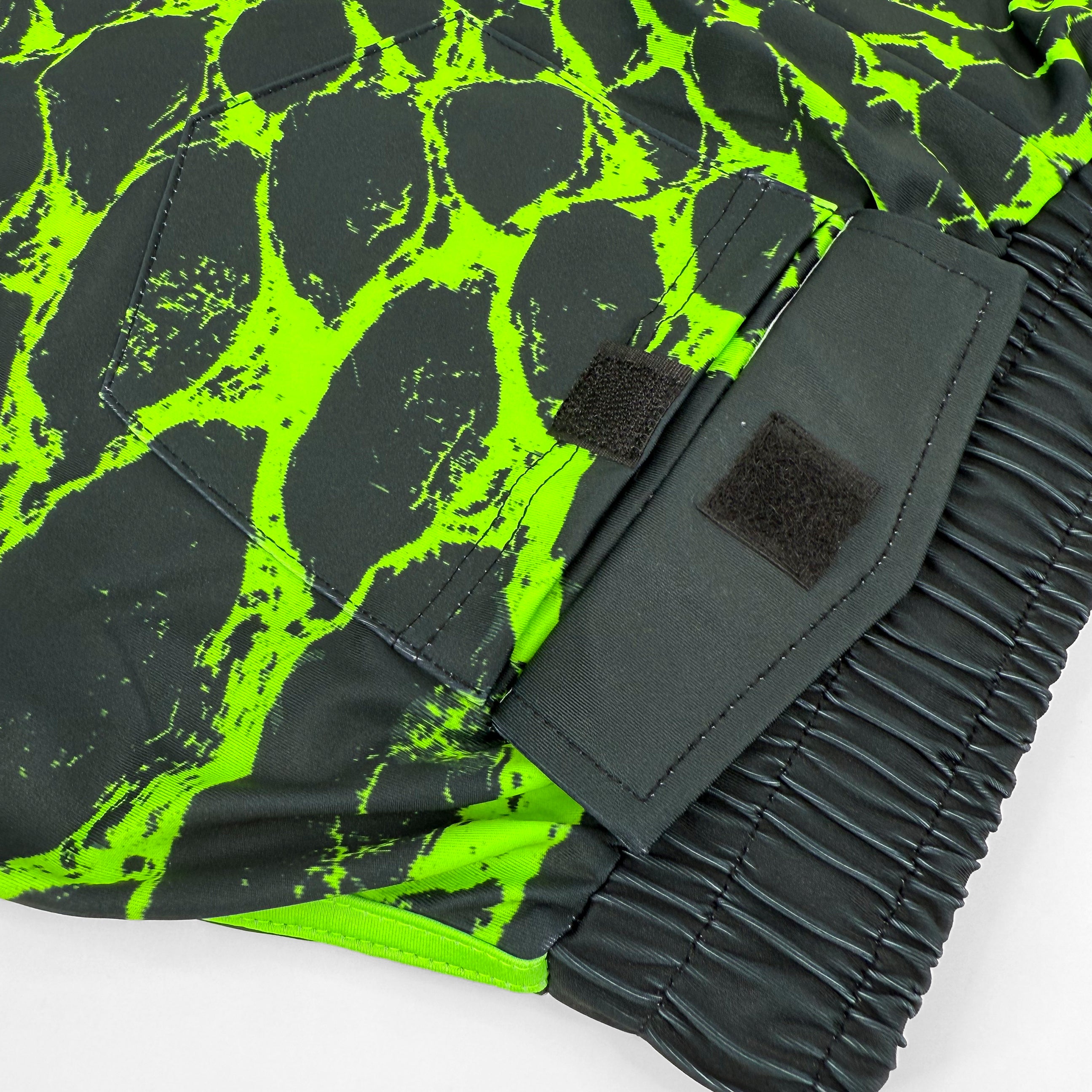 Neon Serpent UV shorts by First Earth – rave-ready shorts with glowing serpent design that shines under blacklight, lightweight breathable mesh, zip and velcro pockets for festival flow
