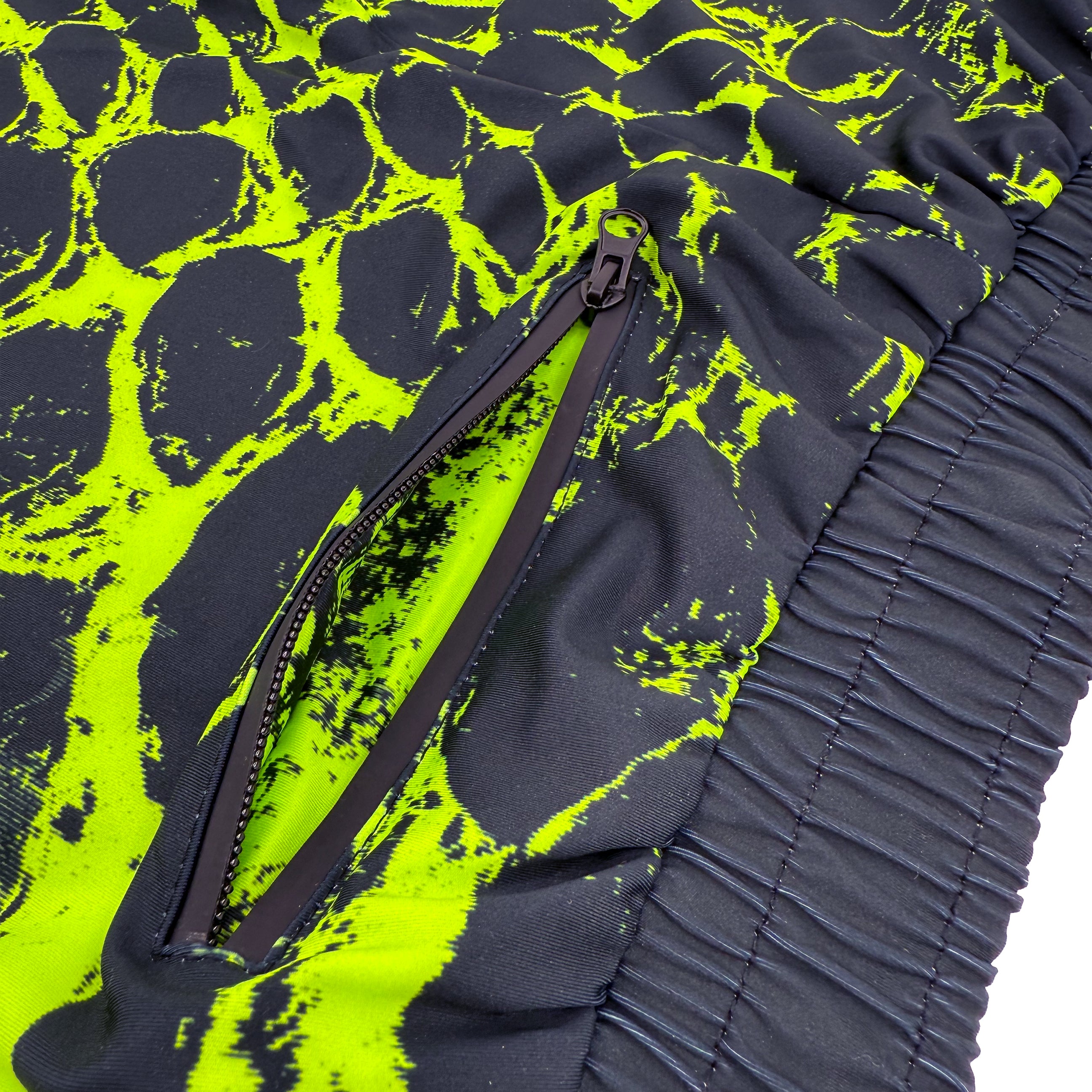 Neon Serpent UV joggers by First Earth – rave-worthy pants with glowing serpent design under blacklight, breathable soft polyester, zip pockets, and elastic drawstring waistband 