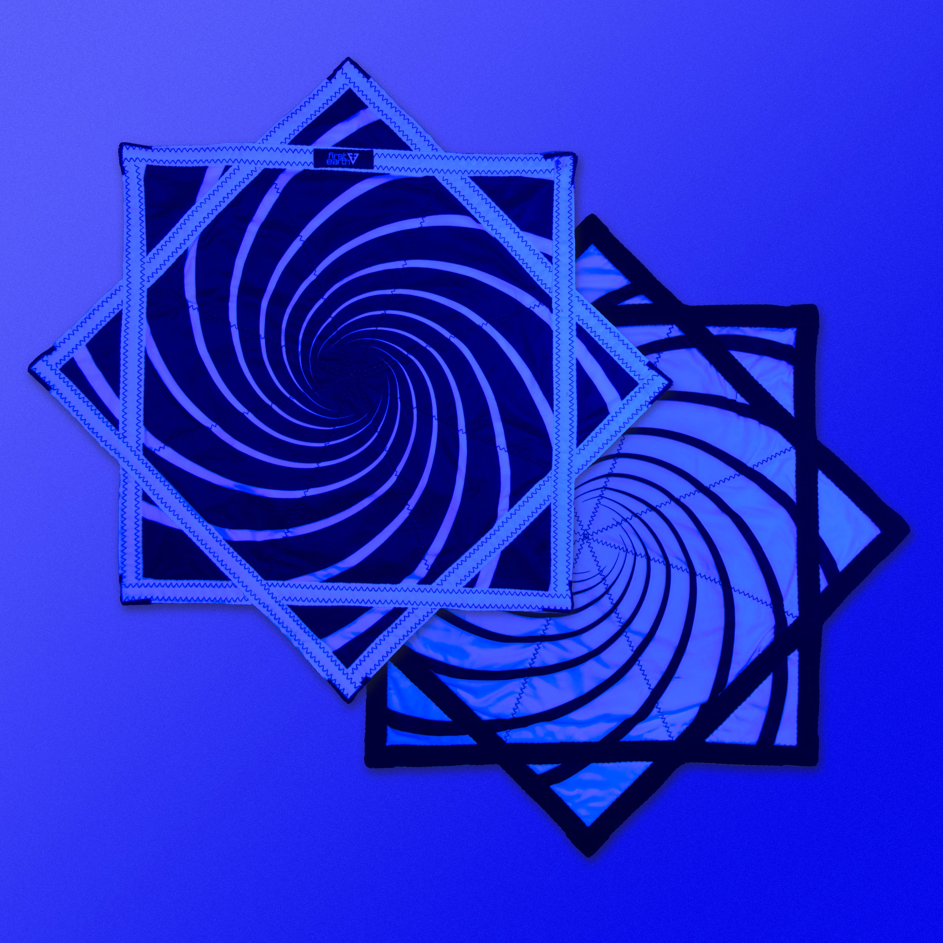 First Earth Spiral 2 UV Flow Star — black and white UV swirl rave prop made for smooth, balanced spinning.