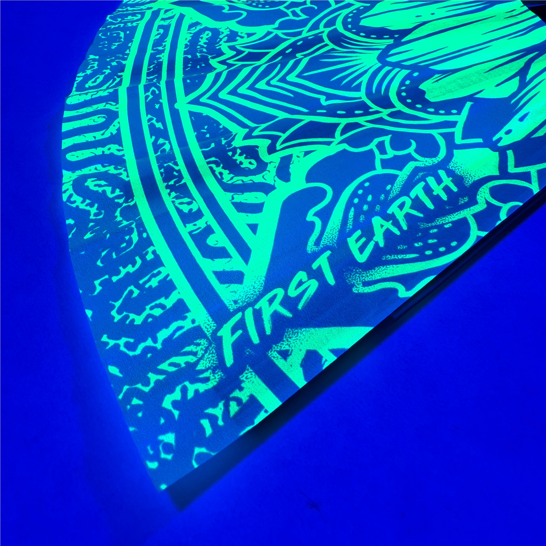 Sunflower UV glow hand fan by First Earth – folding rave fan with glowing sunflower design under blacklight, bamboo frame, and vibrant polyester for airflow on the dance floor 