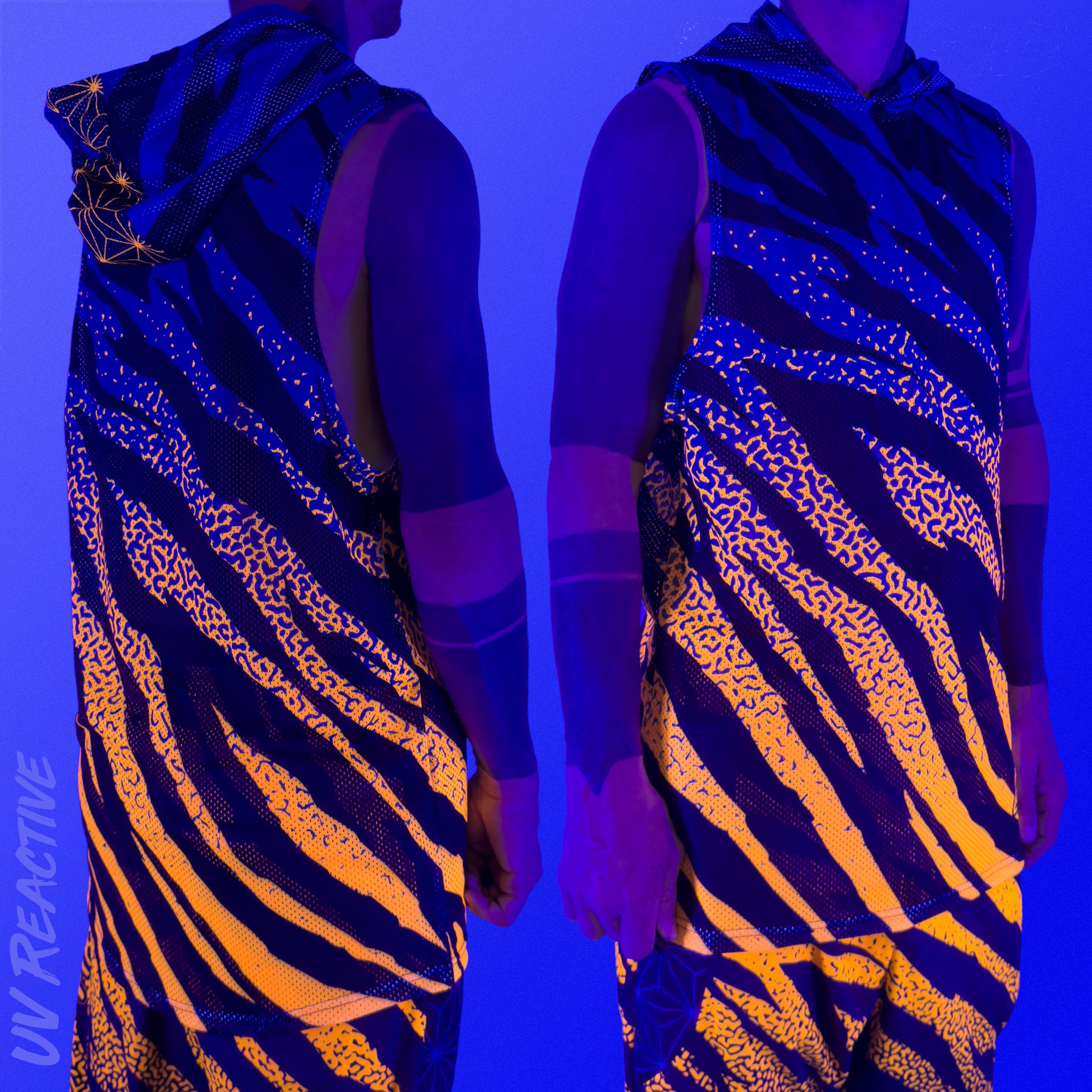 First Earth Sacred Stripes UV hooded mesh tank top under blacklight on model showing glowing orange tiger stripe design front and back