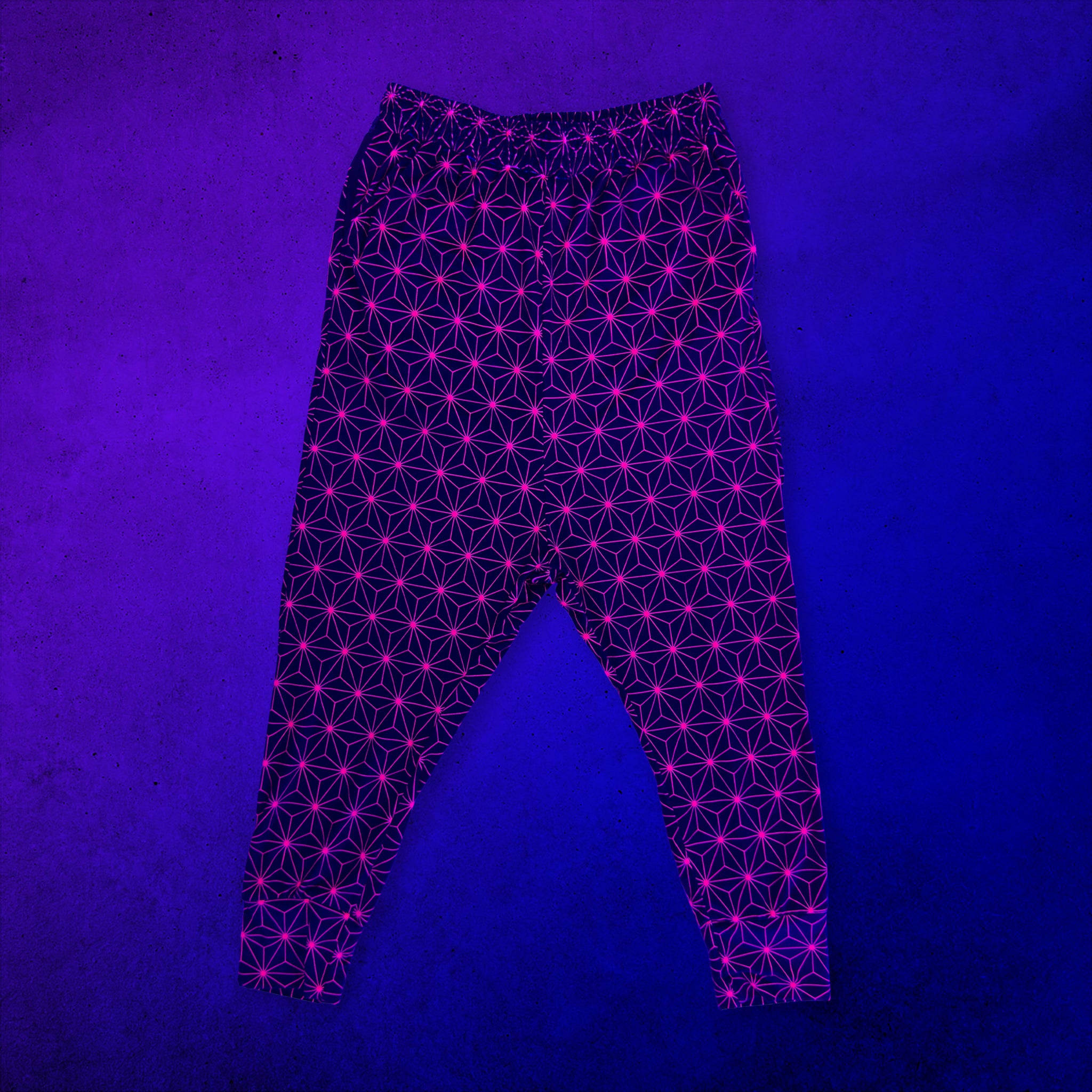 First Earth Asanoha Pink UV velvet harem joggers glowing under UV blacklight