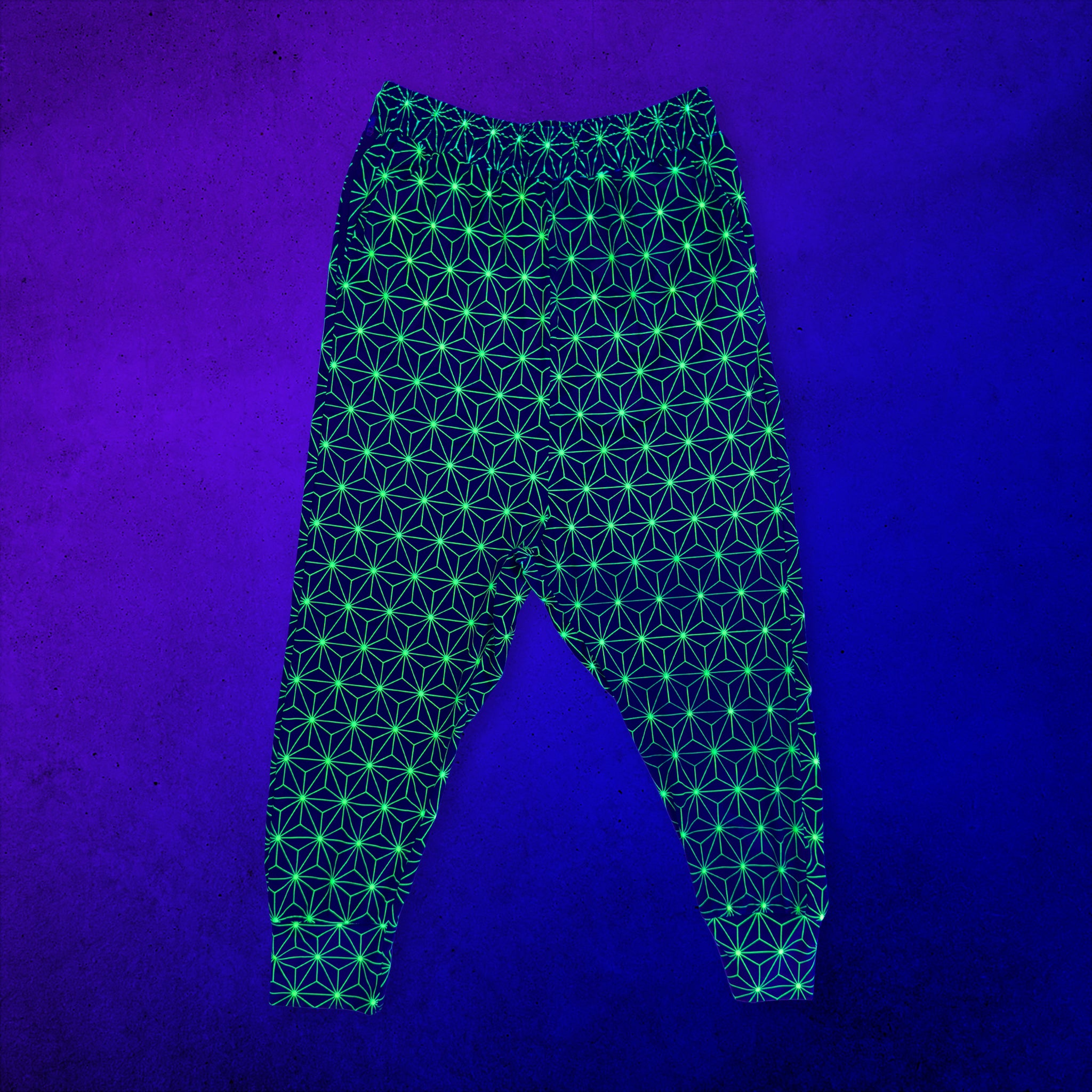 First Earth Asanoha Yellow UV velvet harem joggers glowing under UV blacklight