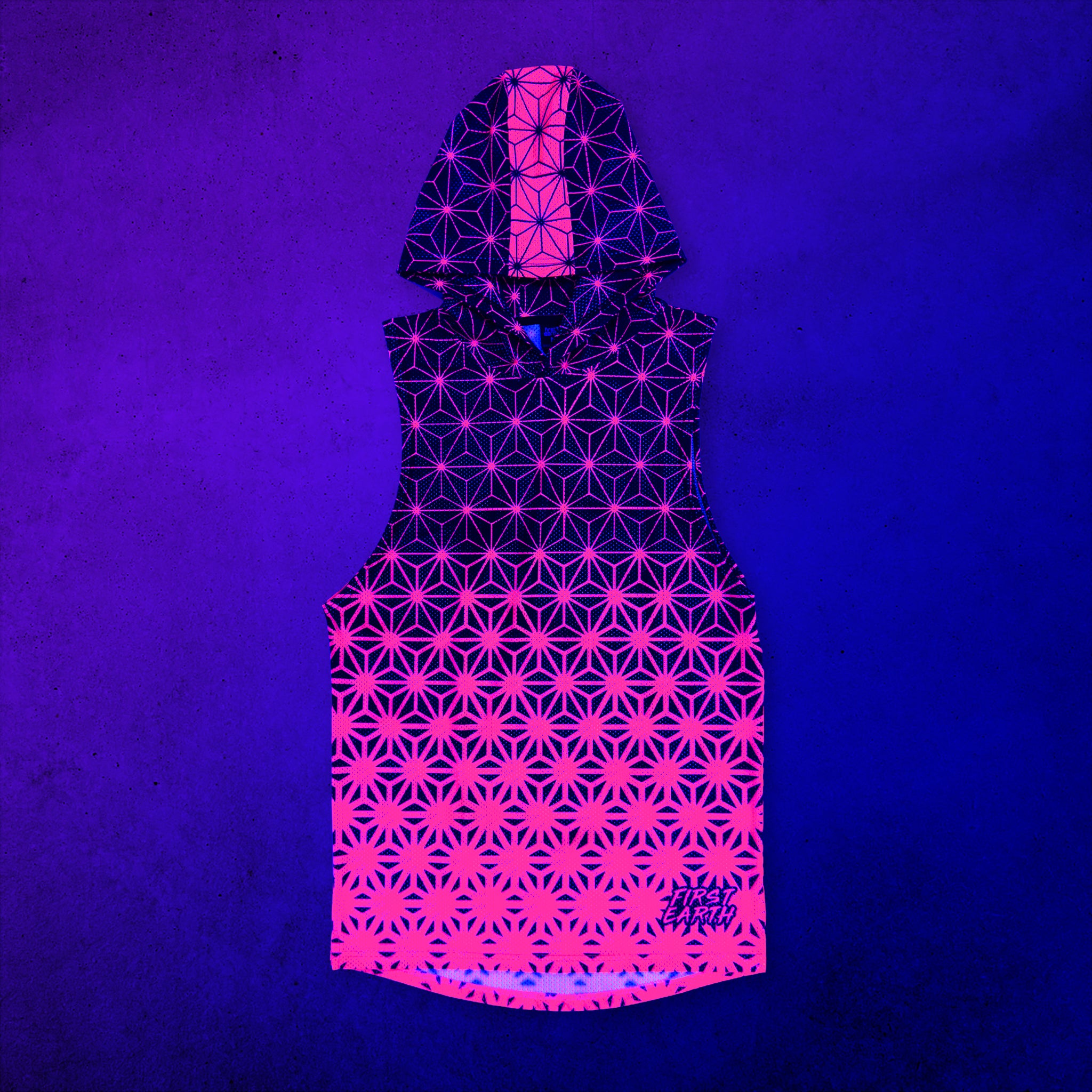 First Earth Asanoha Pink UV mesh hooded tank front glowing under UV black light, with vivid neon pink asanoha geometric pattern on a dark base