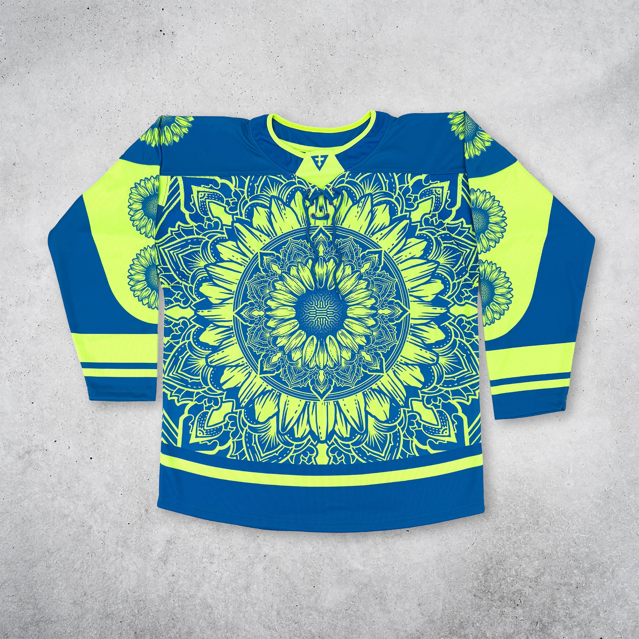 First Earth Sunflower of Life hockey jersey with a blue and yellow sunflower mandala design across the front, long sleeves with sunflower accents and striped detailing, and a front lace-up neckline